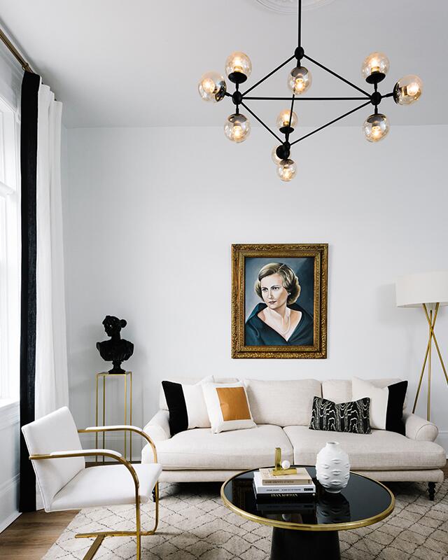 You need to see Havenly Head of Design Shelby Girard's black and white chic, modern home makeover—we love the all white kitchen, black canopy bed, open floor plan, plush seating and palm print wallpaper! Click to see more of this gorgeous space. 