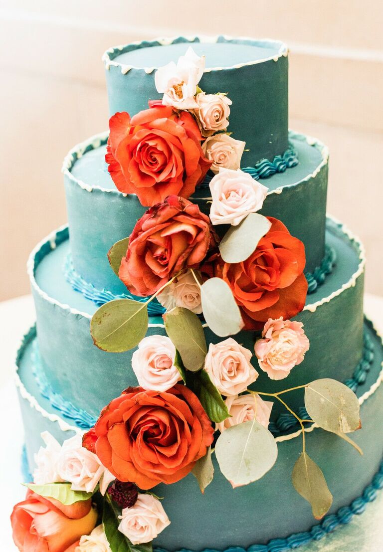 Four-tier teal cake with fresh red roses