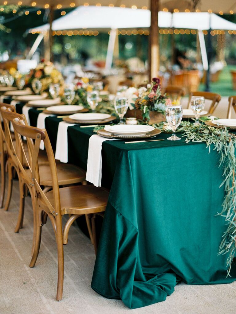 Emerald green table cloth at outdoor tented wedding reception