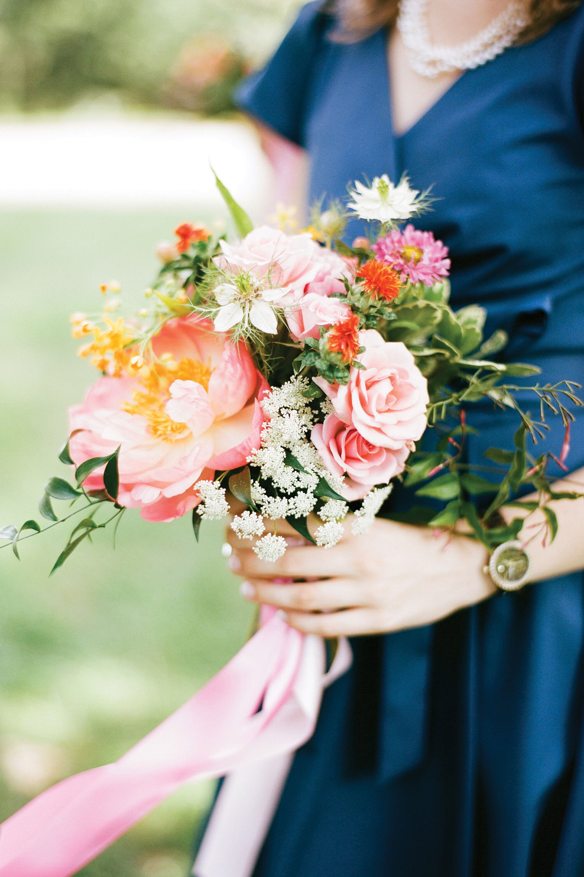 bridesmaid holding single flower