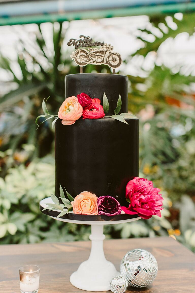 Two-tier black wedding cake with motorcycle cake topper