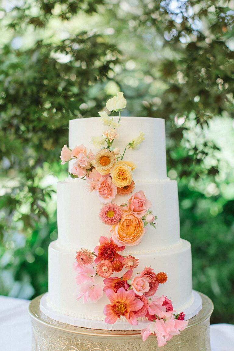 Three-tier cake with ombre cascade of fresh flowers.