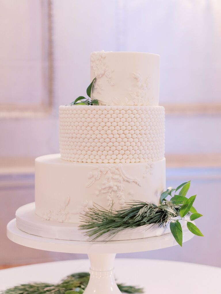 Three-tier white staircase wedding cake