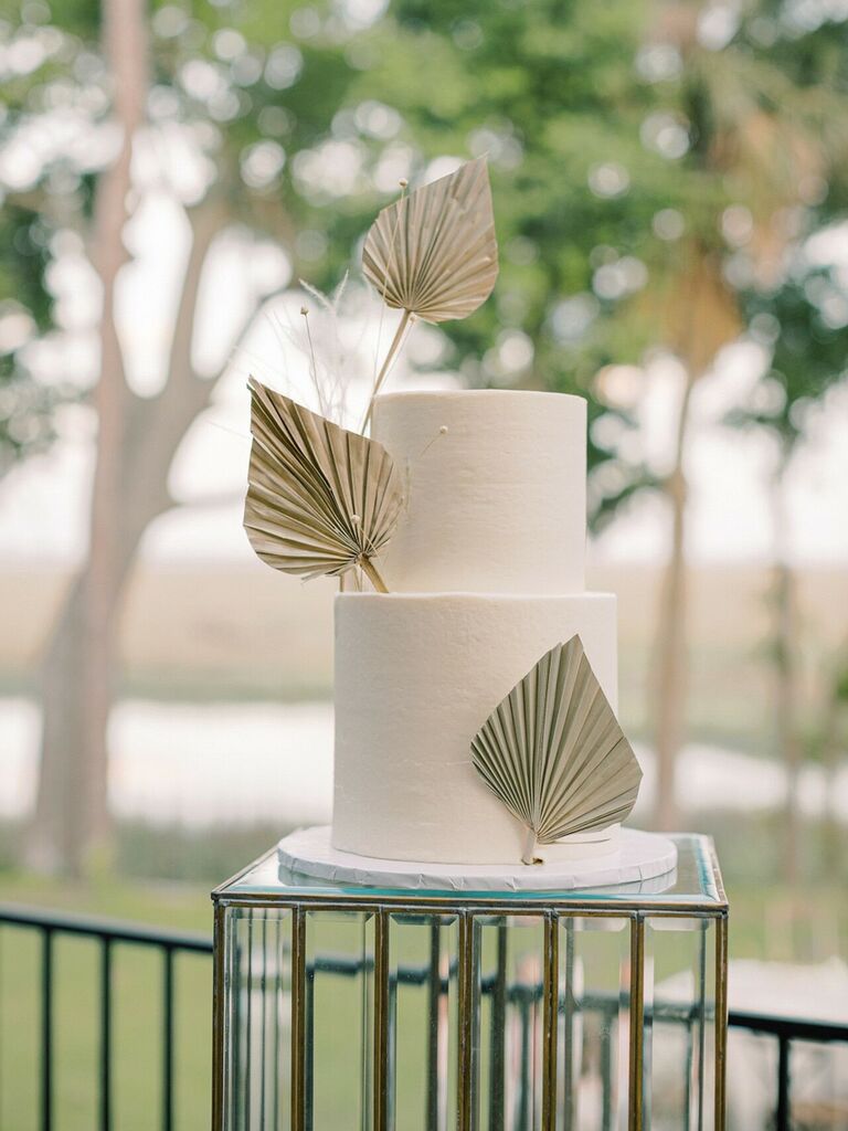 Modern two-tier wedding cake with fan-inspired decorations