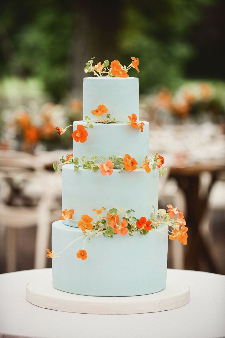 four-tier sky blue cake with orange nasturtiums