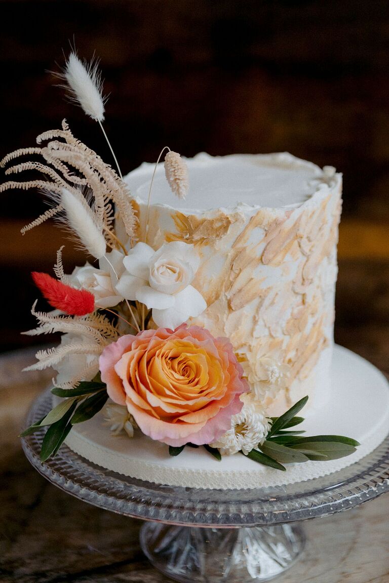 Textured beige wedding cake with flower decorations